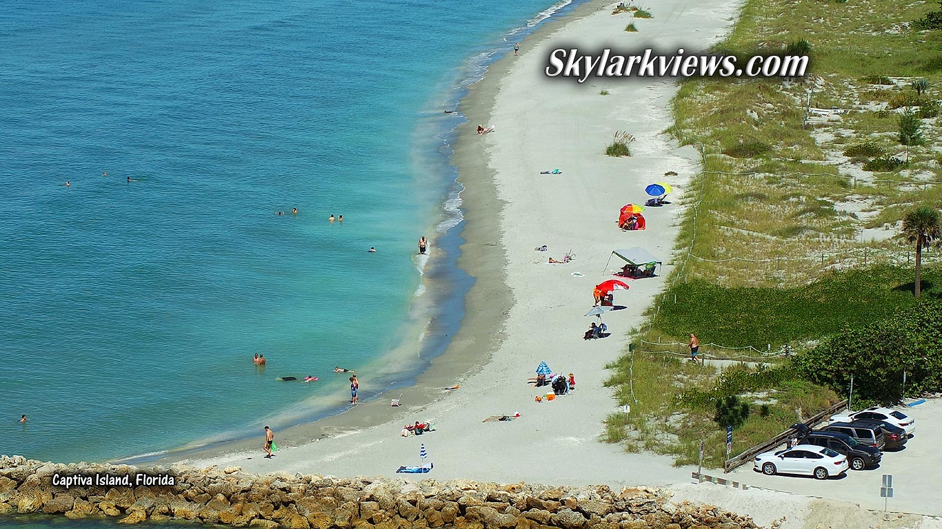 people swimming and sunbaking at the beach