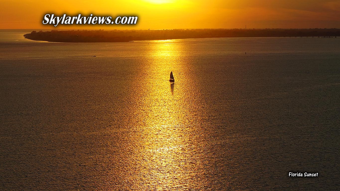 sailboat at golden sunset - aerial view