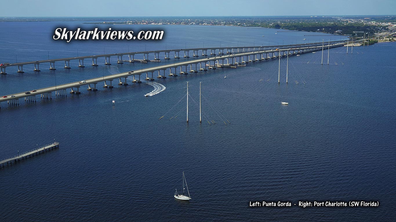 two long road bridges crossing wide river