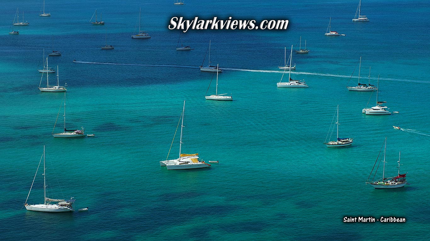 lots of sailboats and catamarans seen from above