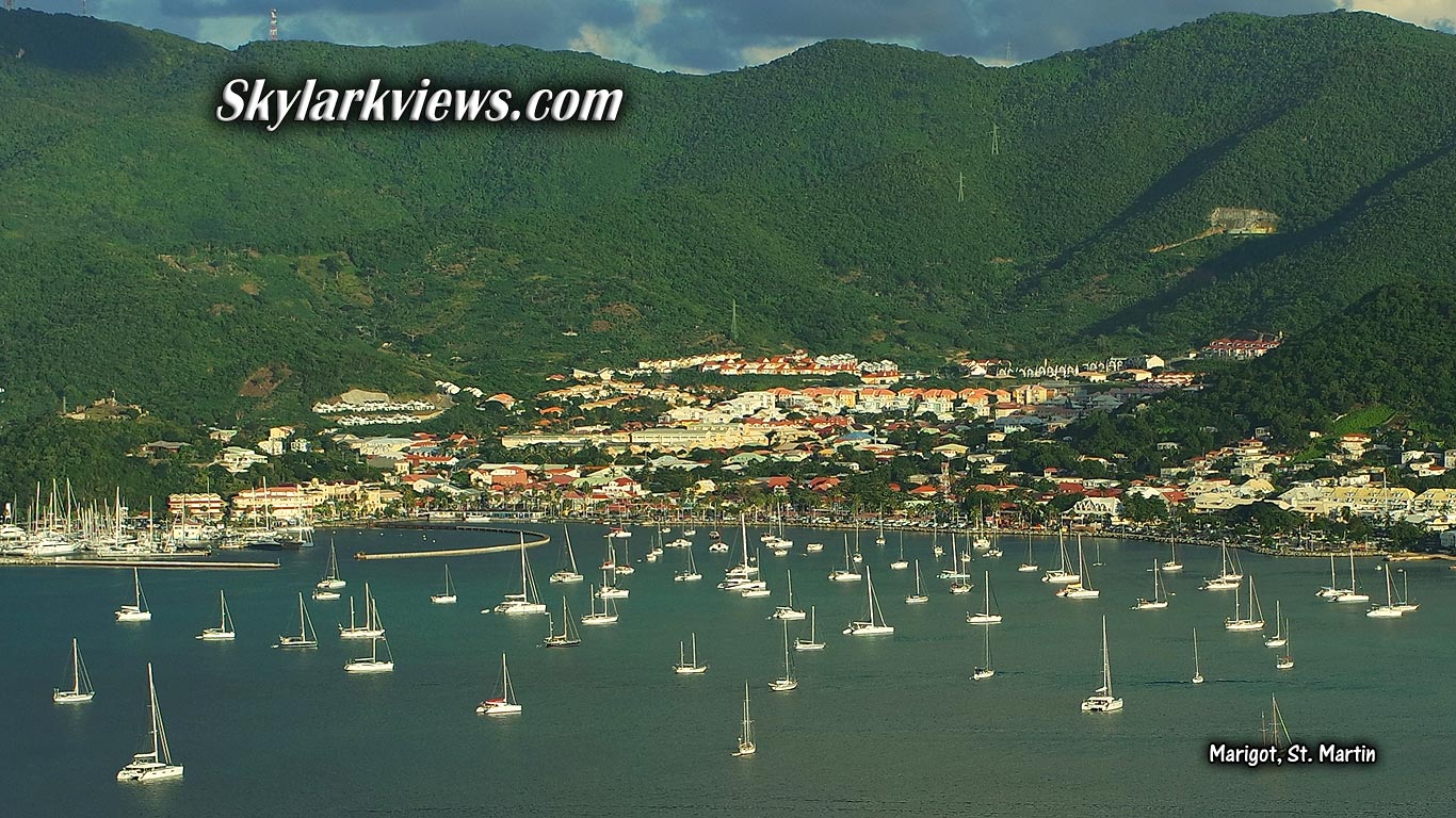 ocean, many sailboats, little city and mountains