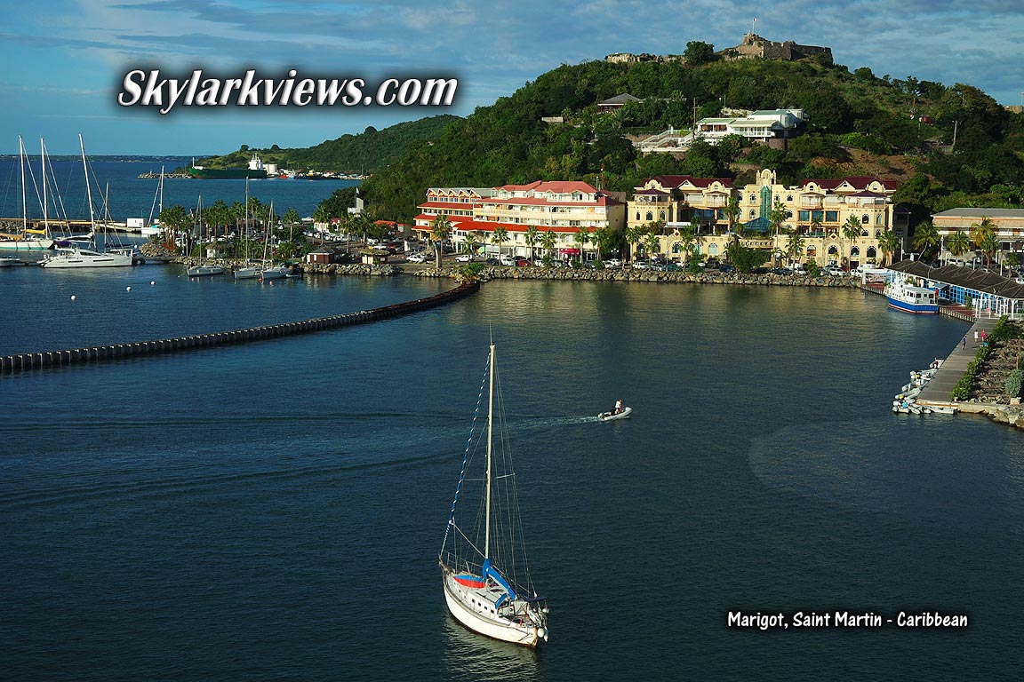 sailboat in the front, ocean promenade and Fort on a hill