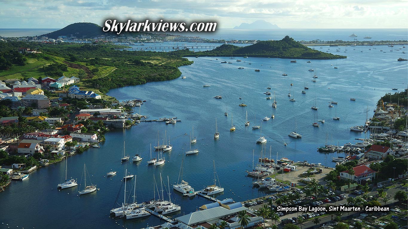 many sailboats, hoiuses at waterfront, bay, ocean